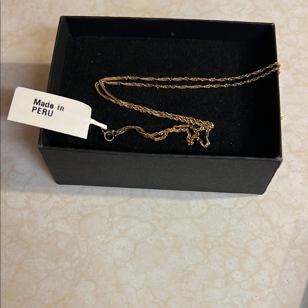 With tags but tarnished clasp area 10k gold 20 inch 0.2 singapore chain